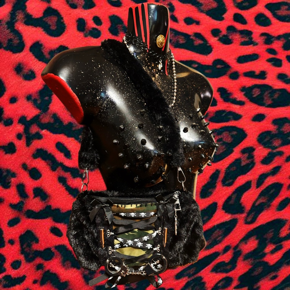 Black and camo bag with metal handcuff and two silver bullet